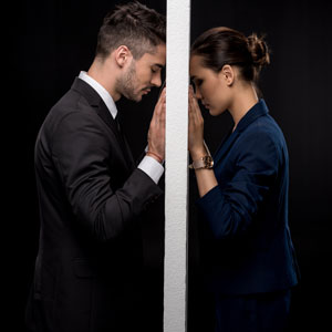 A couple's eyes meet through a doorway, reflecting the emotional turmoil of divorce - THE LAW OFFICES OF DIANE ANDERSON